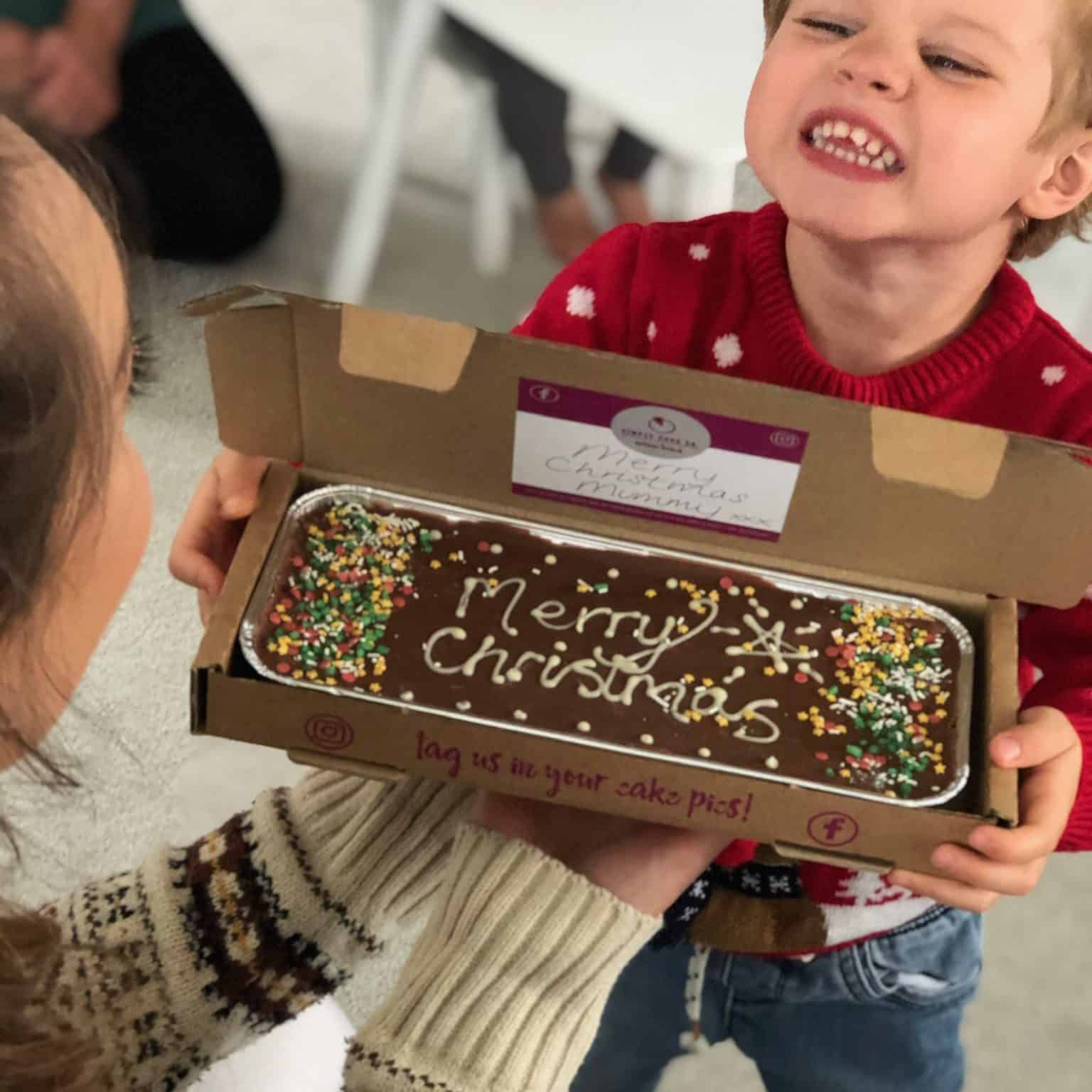Image of a child delivering a personalised Christmas brownie