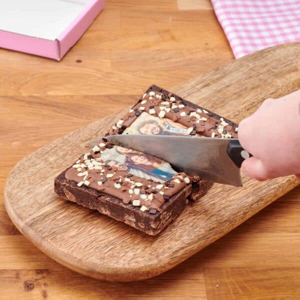 Action shot of slicing a personalised brownie slab