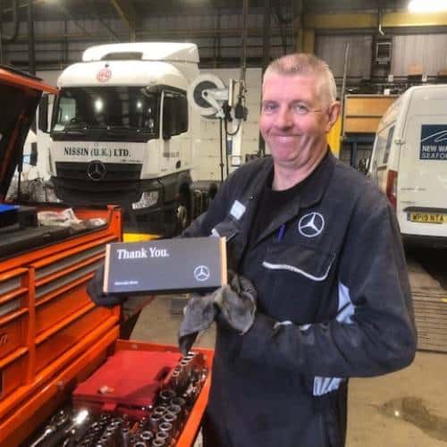 Image of Mercedes worker accepting our corporate gifts