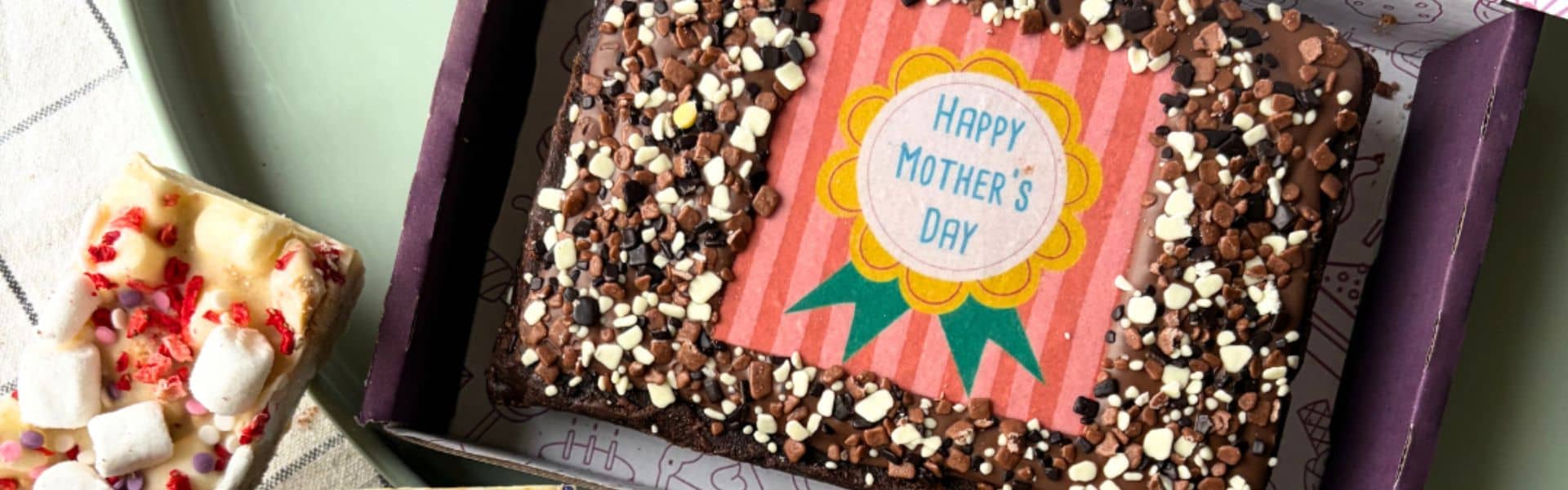 Chocolate Mother’s Day cake with sprinkles and a "Happy Mother’s Day" topper.